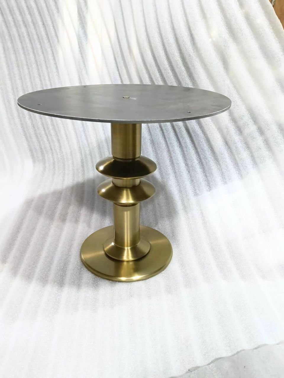 Pedestal side table with a turned brass base