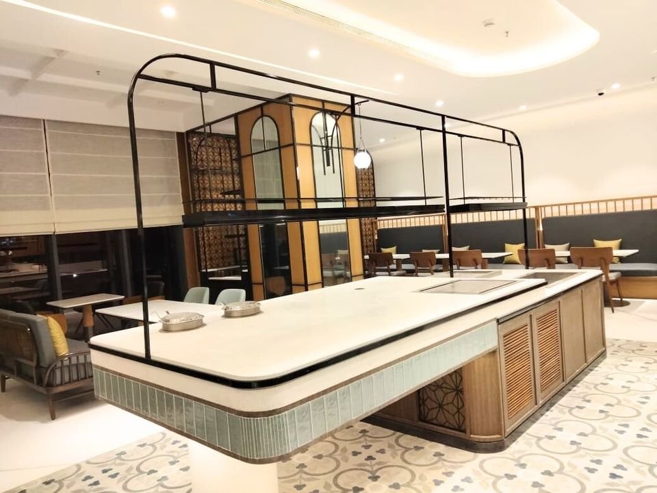 Café island counter under a metal frame canopy