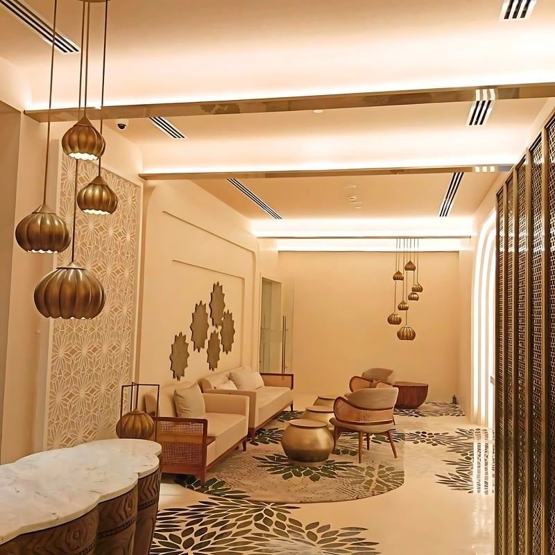 Spa lounge with brass pendants and relief wall panels