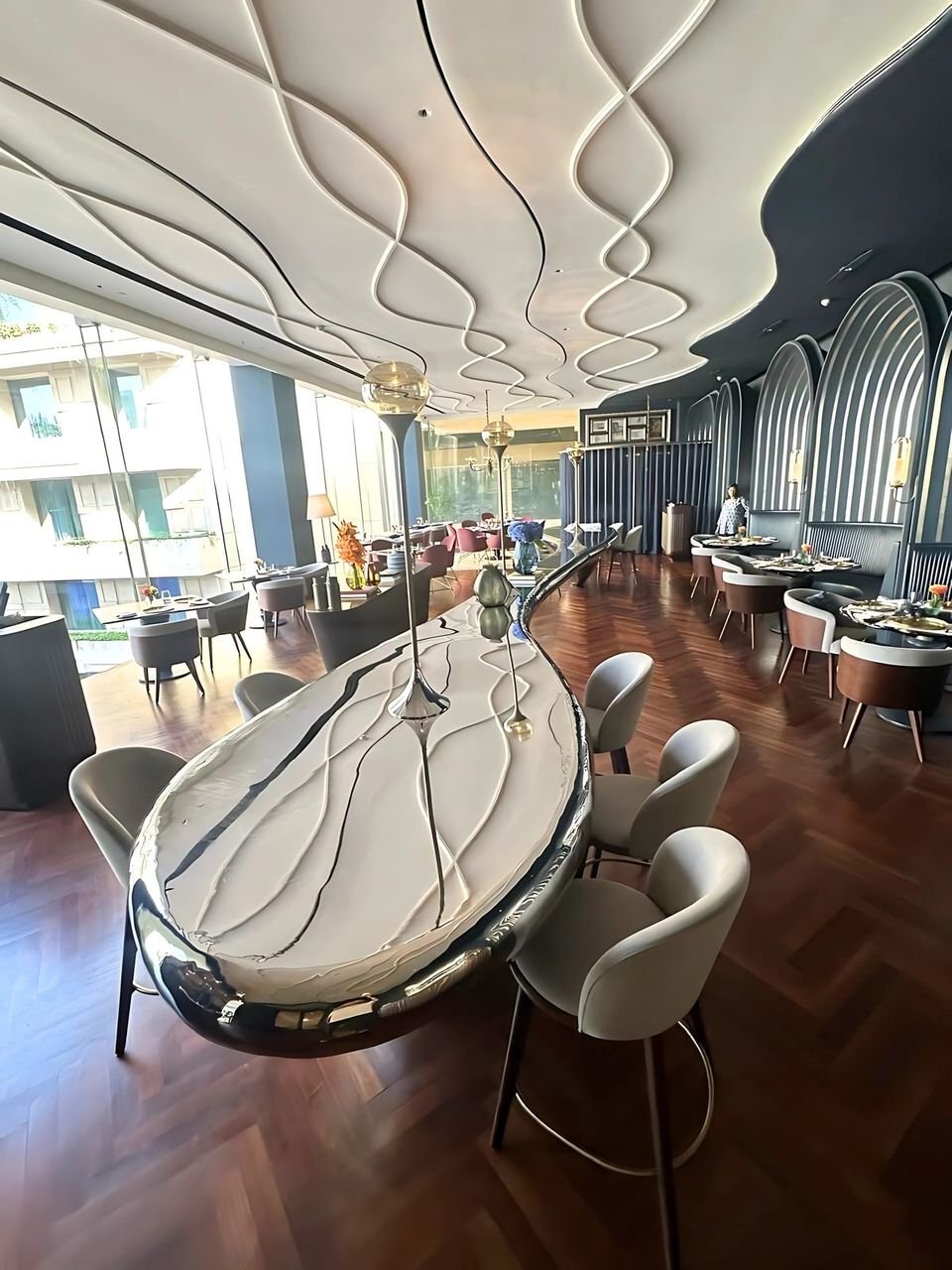 Dining area under a flowing plaster ceiling