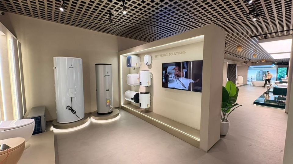 Hot water solutions. Water heaters and storage cylinders on lit plinths within a framed display bay.