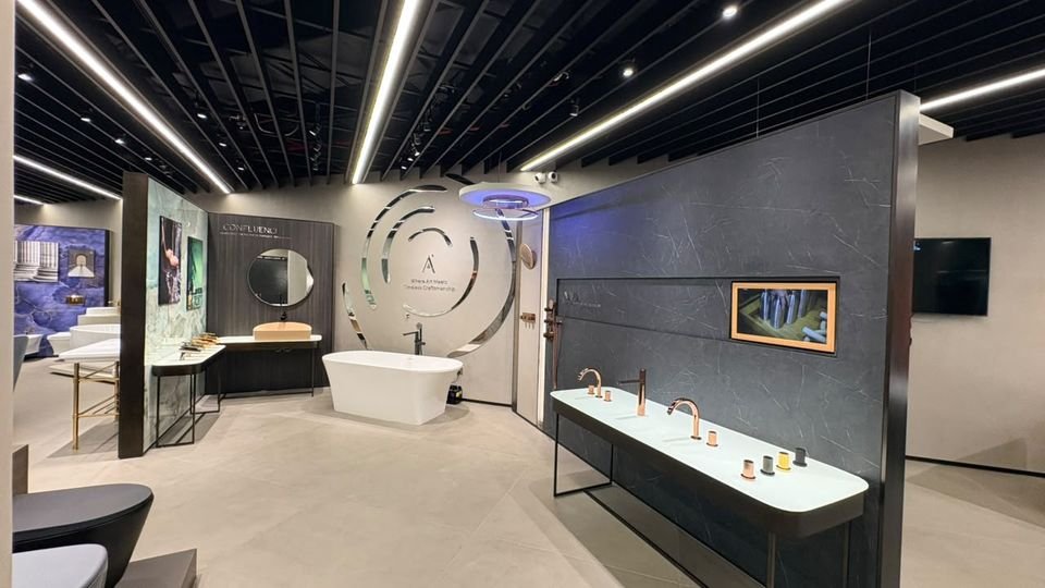 Ring feature & copper fittings. The circular Artize feature, a freestanding bath and a basin console with copper-tone mixers.