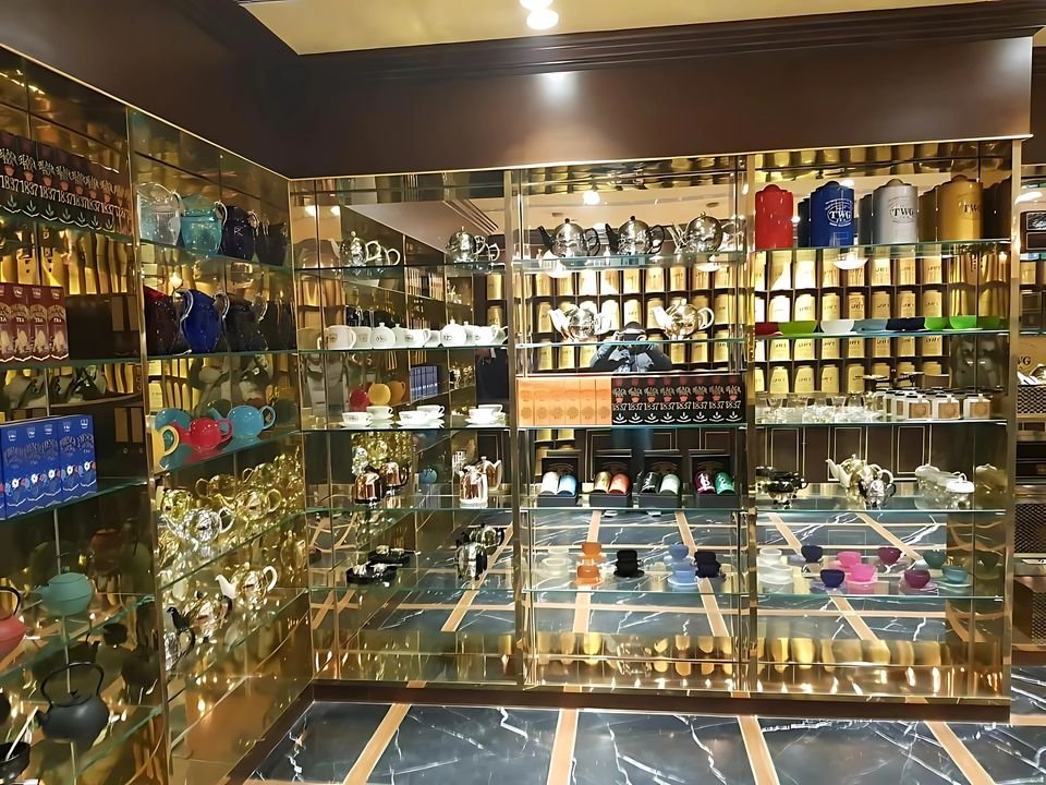 Retail store with brass-framed shelving and patterned flooring
