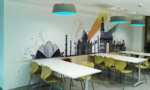 Staff dining area with a city-skyline mural
