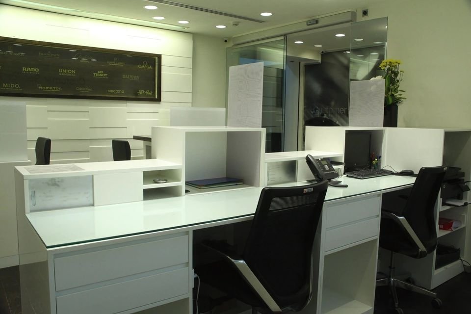 Service desks with white panelled walls and task seating