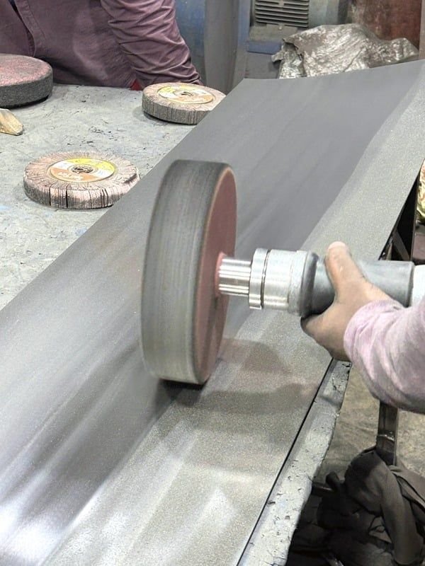 Polishing a stainless steel surface with a flap wheel